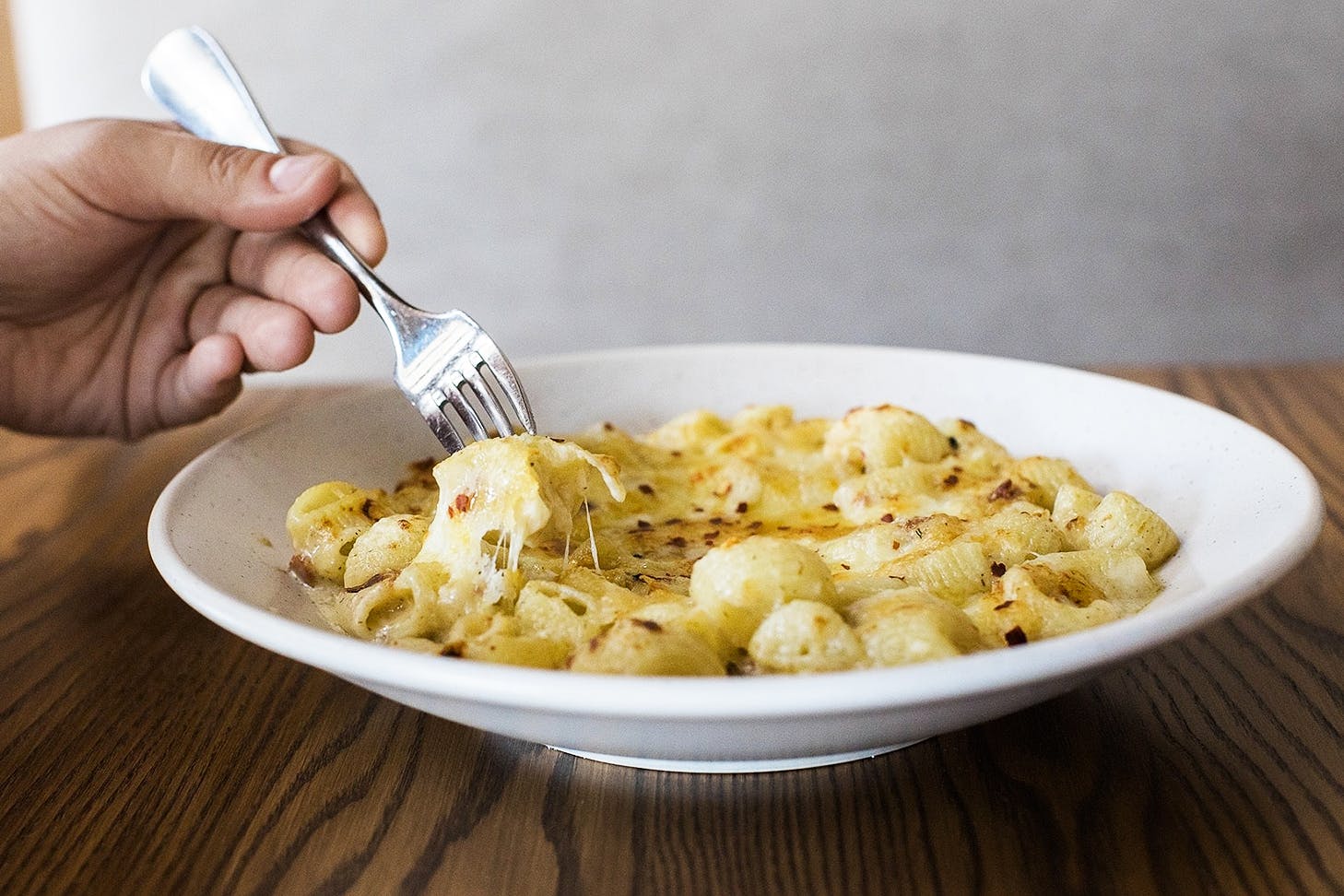 A fork digs into the mac n cheese from Andiamo